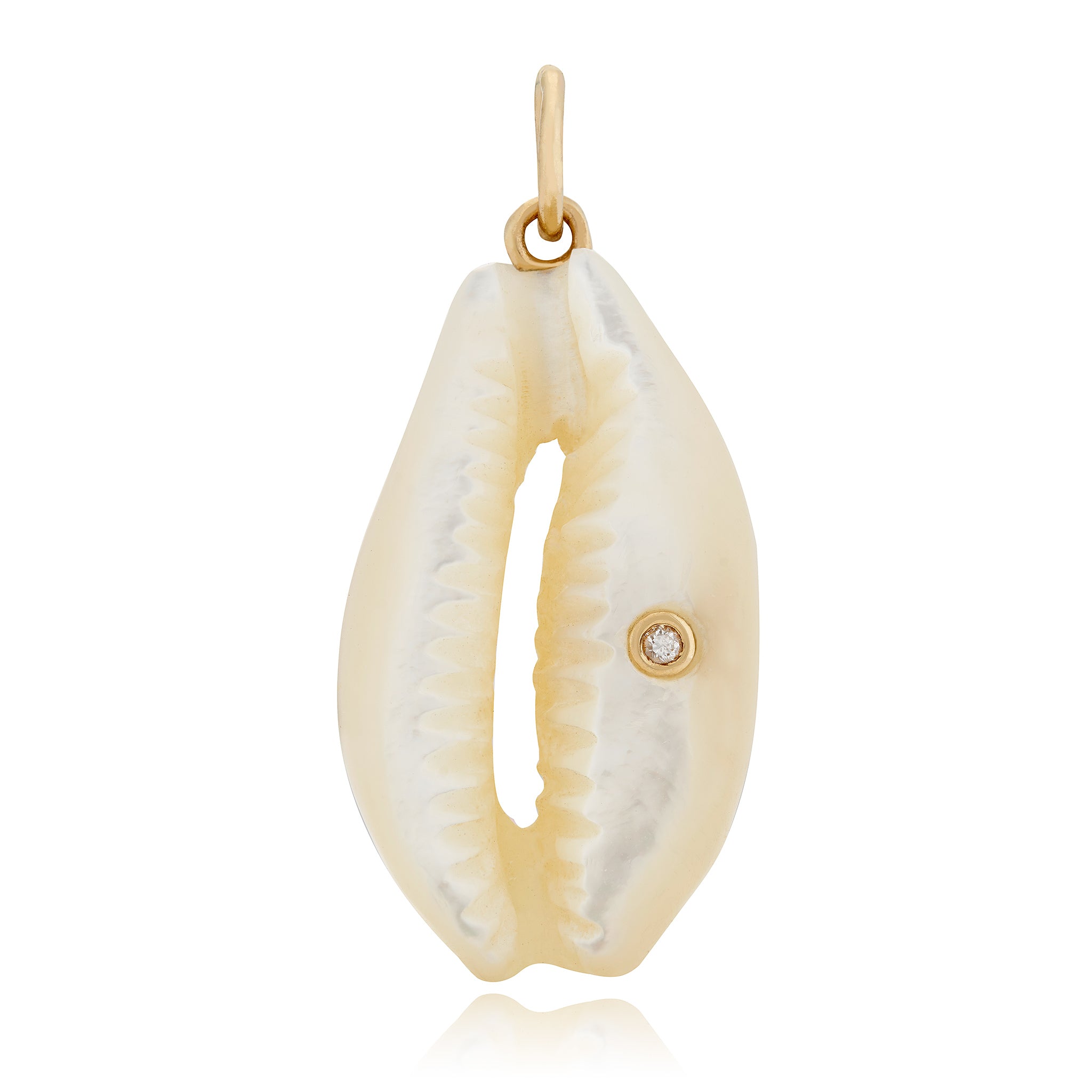 A large cowrie shell charm with a diamond accent, hand-carved from white mother of pearl, set in 14K yellow gold, designed by Maura Green.