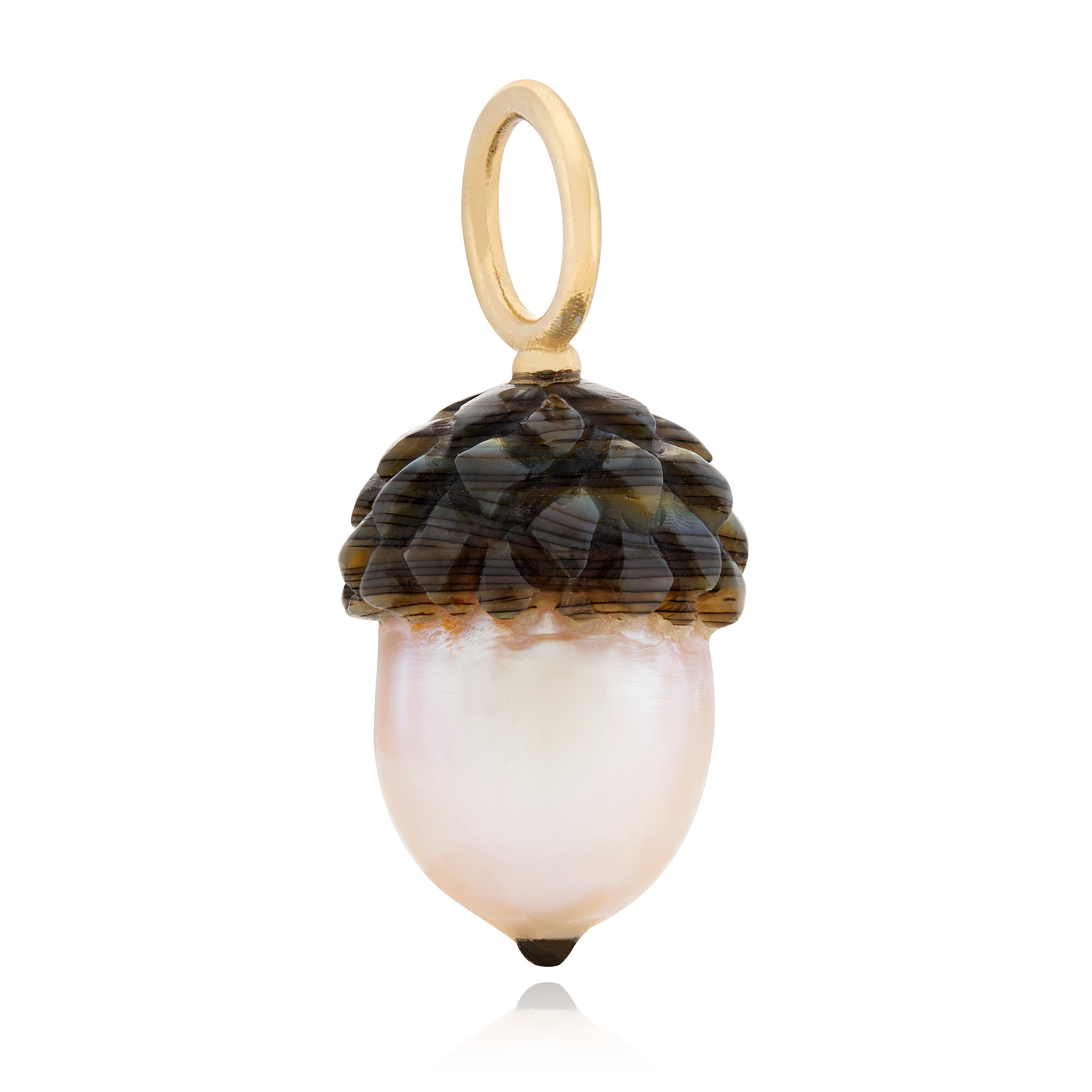 A hand-carved pearl acorn charm with a solid gold bail, featuring intricate details designed by Maura Green