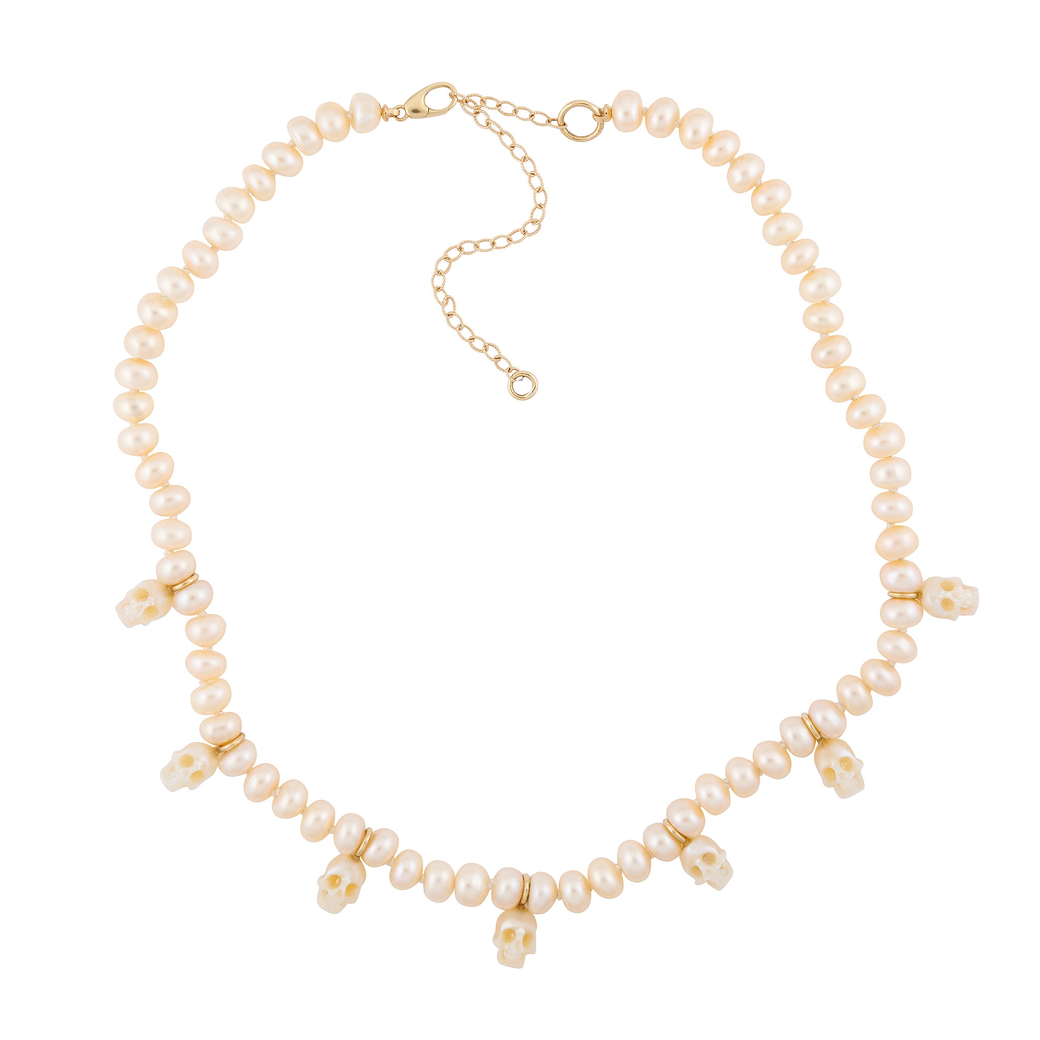 A pearl choker necklace with gold bails and miniature skulls designed by Maura Green
