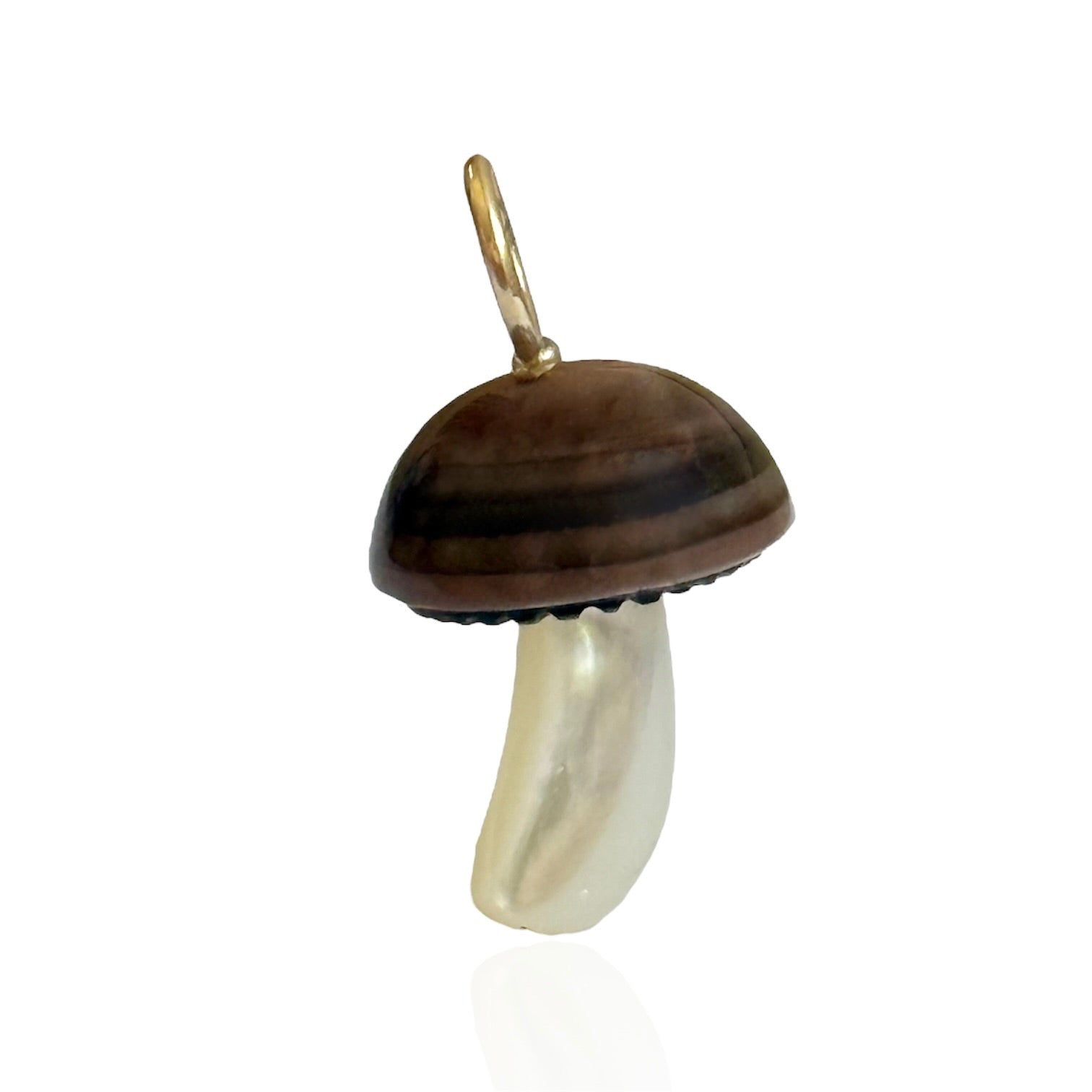 Mushroom-shaped pendant with brown cap and white stem designed by Maura Green