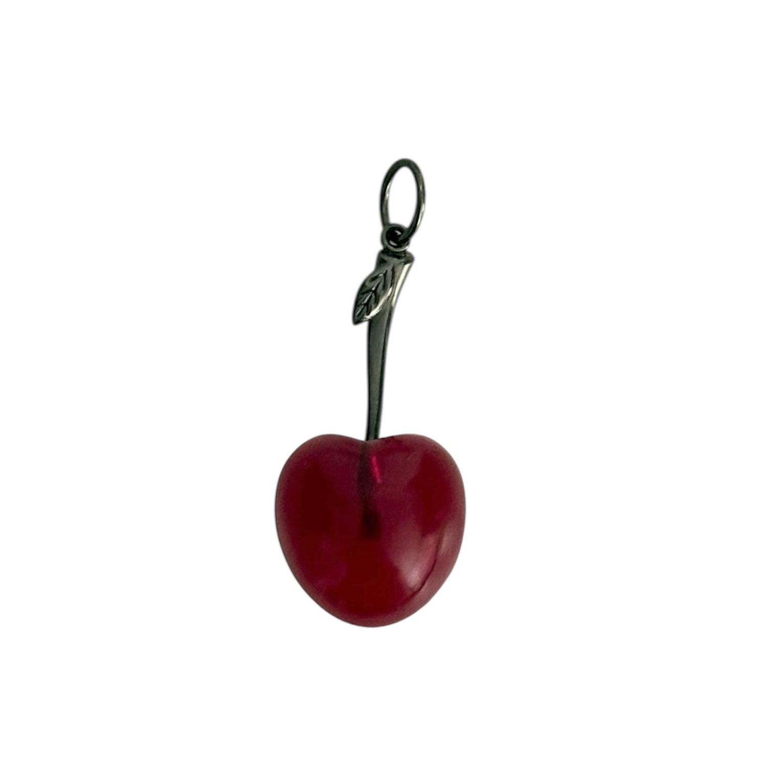 Red cherry charm with a silver stem on a white background. Designed by Maura Green.