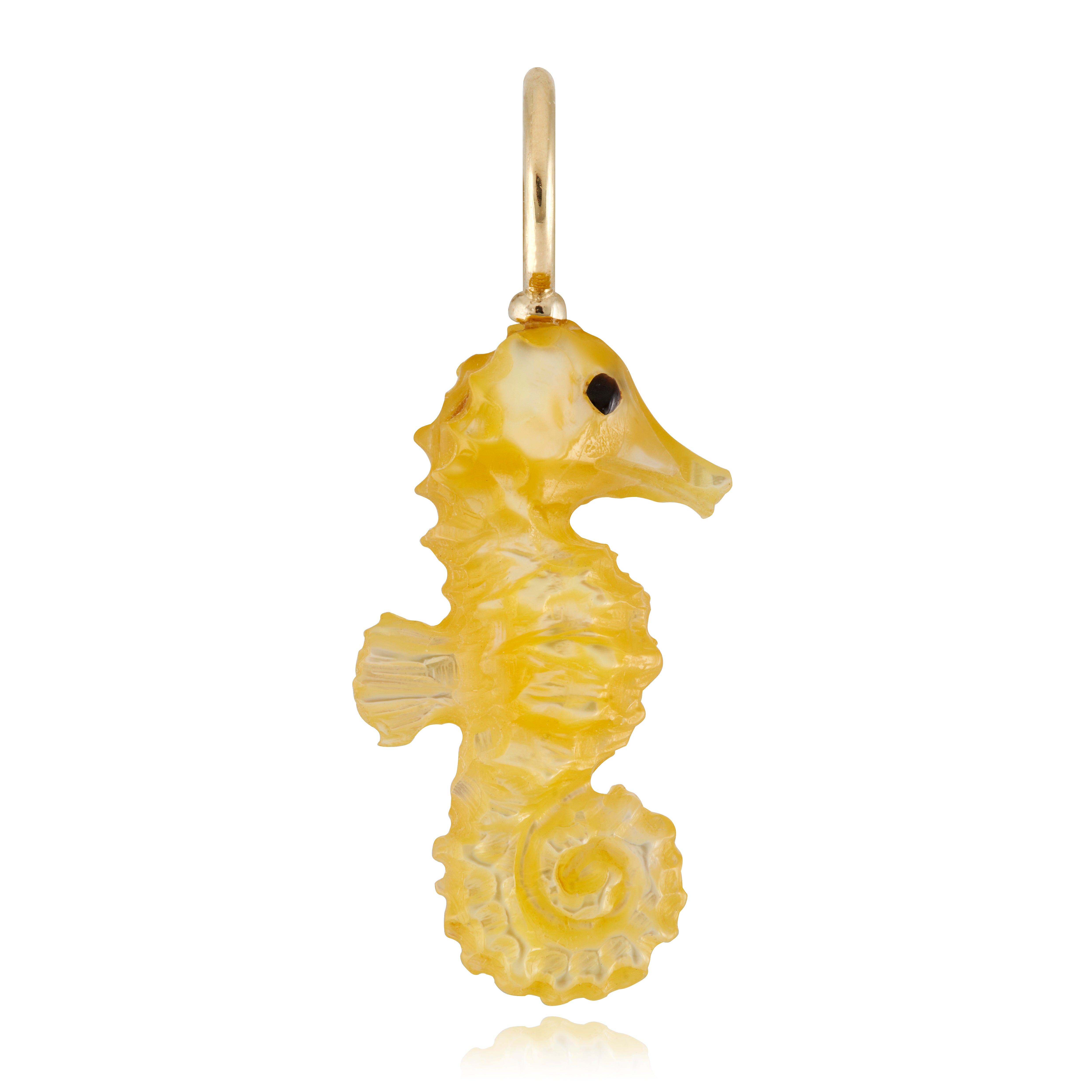 Gold mother of pearl seahorse charm on a white background designed by Maura Green