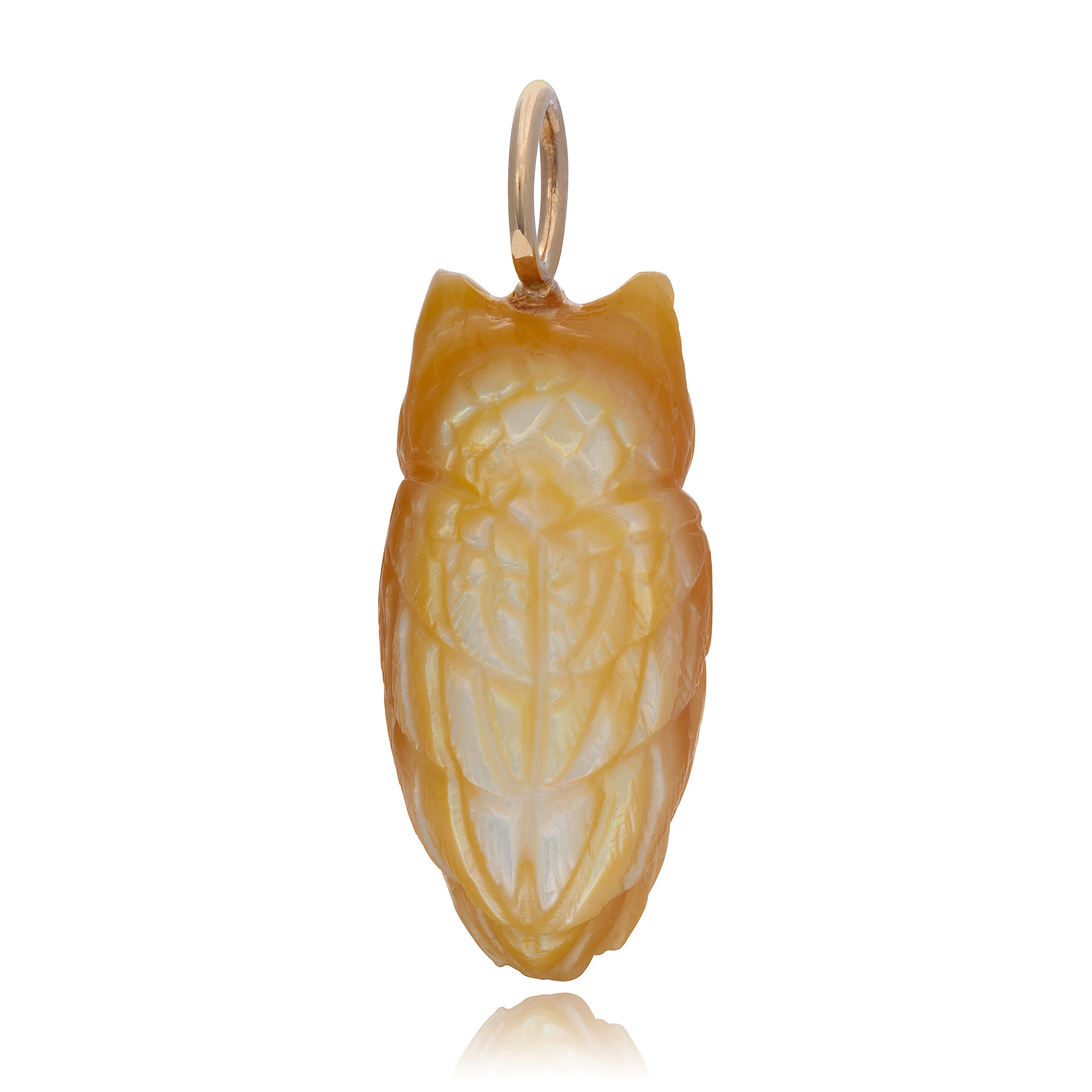 The back view of a 3rd carved golden mother of pearl owl charm with a gold bail, in front of a white background. Designed by Maura Green.