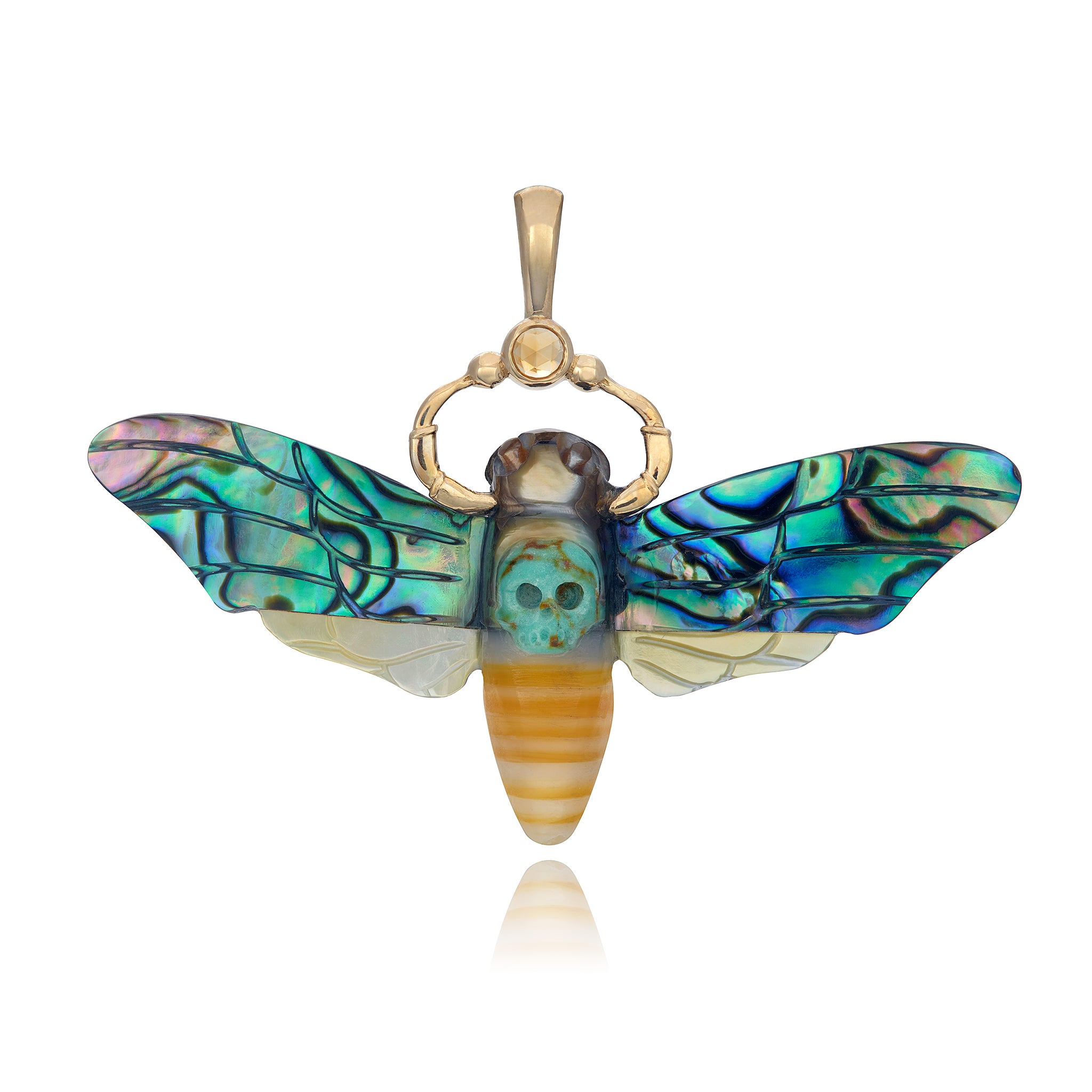 A hand-carved abalone, mother of pearl, and turquoise jasper pendant in the shape of a Death's Head Hawk Moth, set in 14K yellow gold with a rose cut citrine.