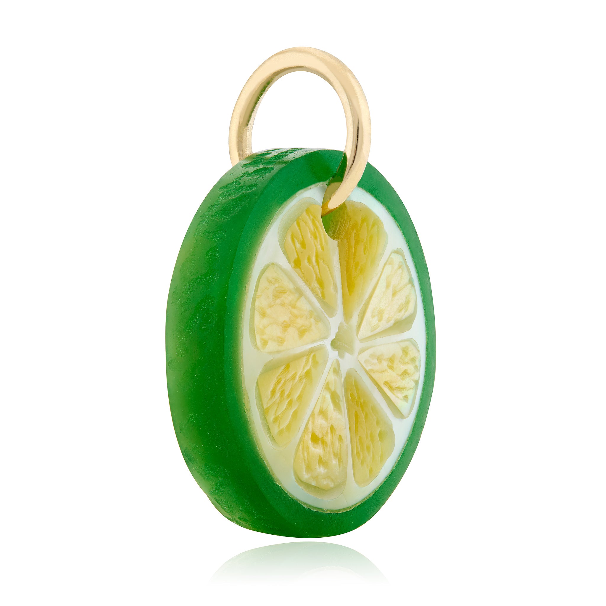 A realistic hand carved green lime slice charm shown in 3/4 view with a 14K yellow gold bail against a white background. Designed by Maura Green.