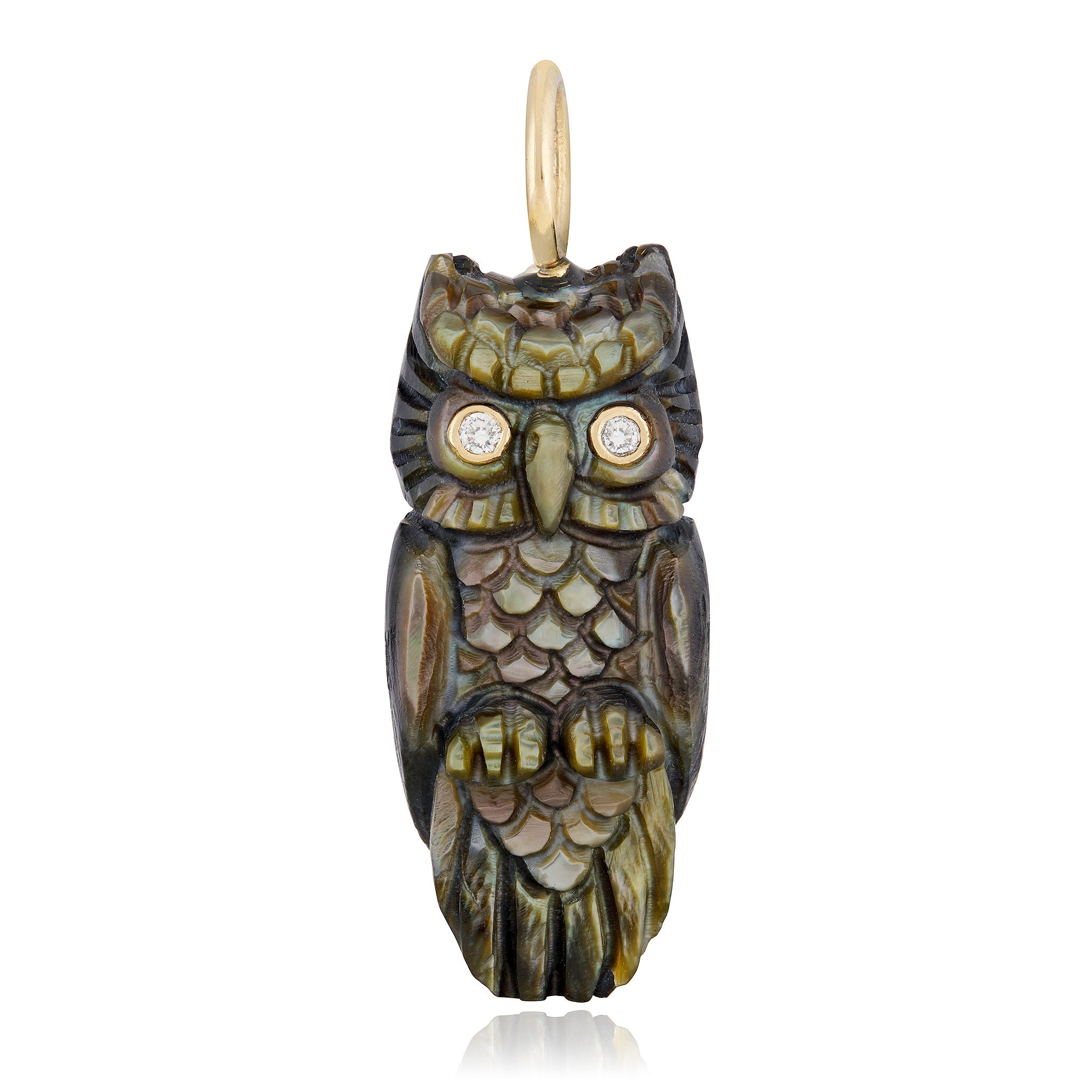 A 3D carved owl charm designed by Maura Green, made from black mother of pearl with 14K solid gold and diamond eyes against a white background.