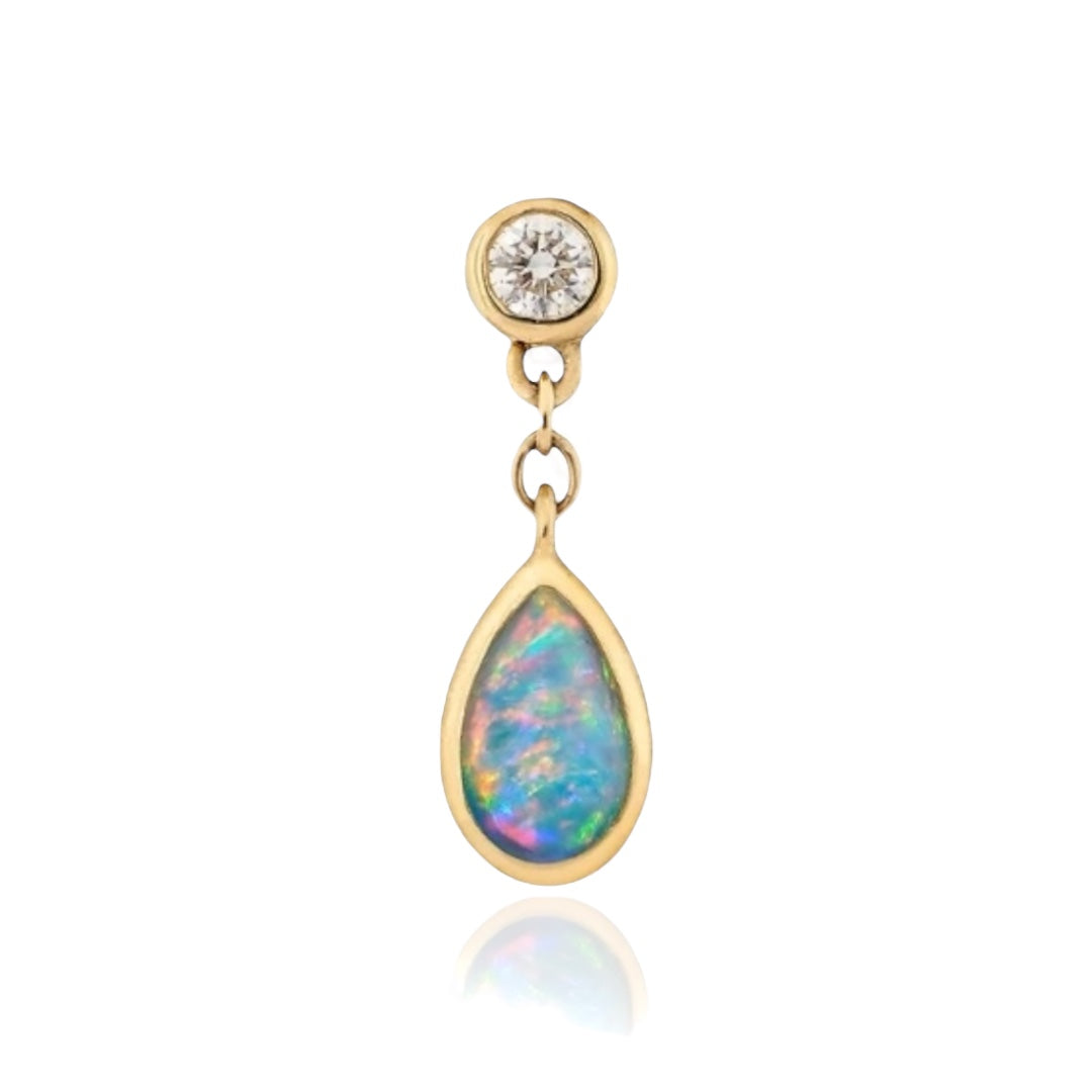 Gold earring with a teardrop-shaped opal and round diamond on a white background by Maura Green