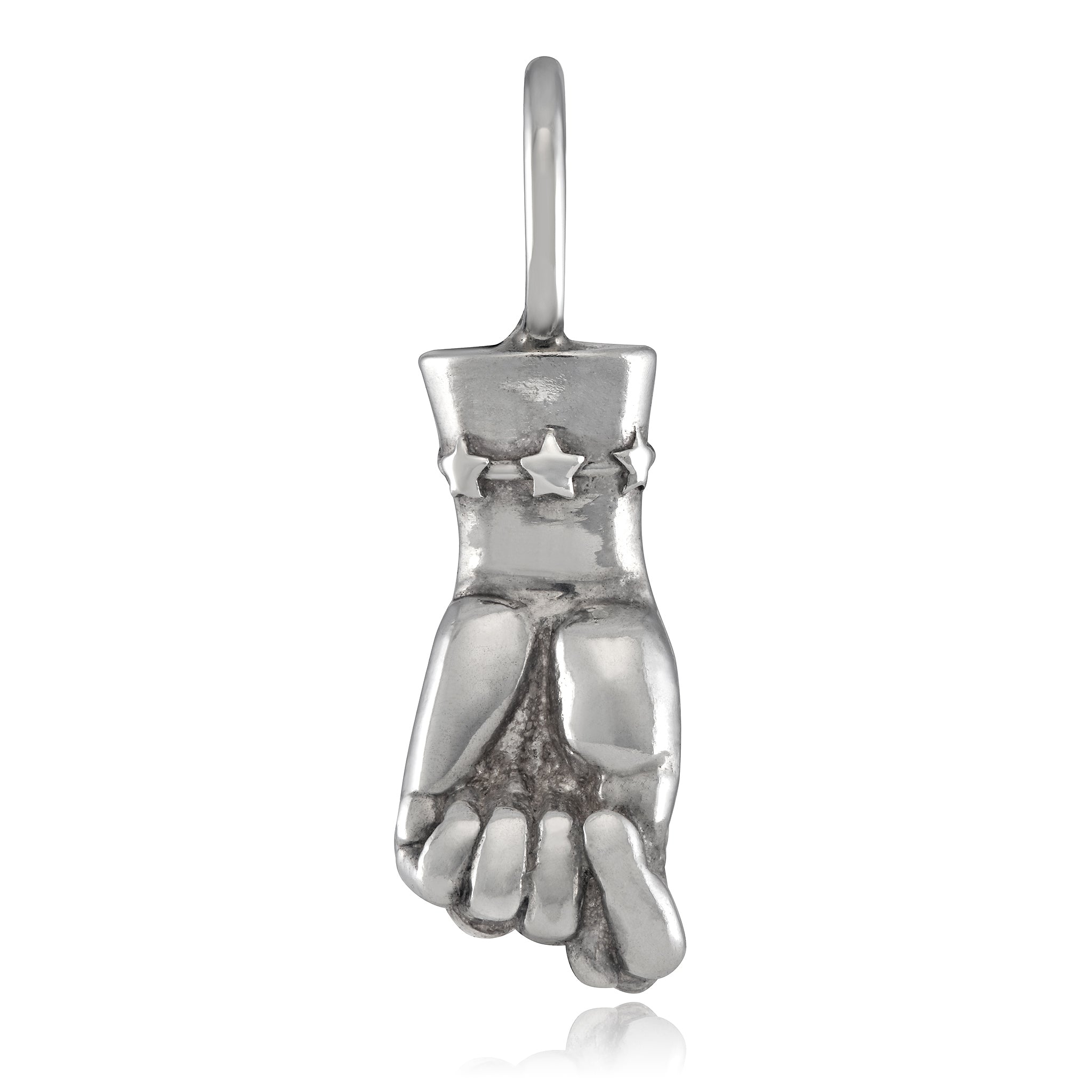 A silver-colored figa charm in the shape of a female hand, with a star detail on the wrist designed by Maura Green Jewelry for her ladyfinger collection.