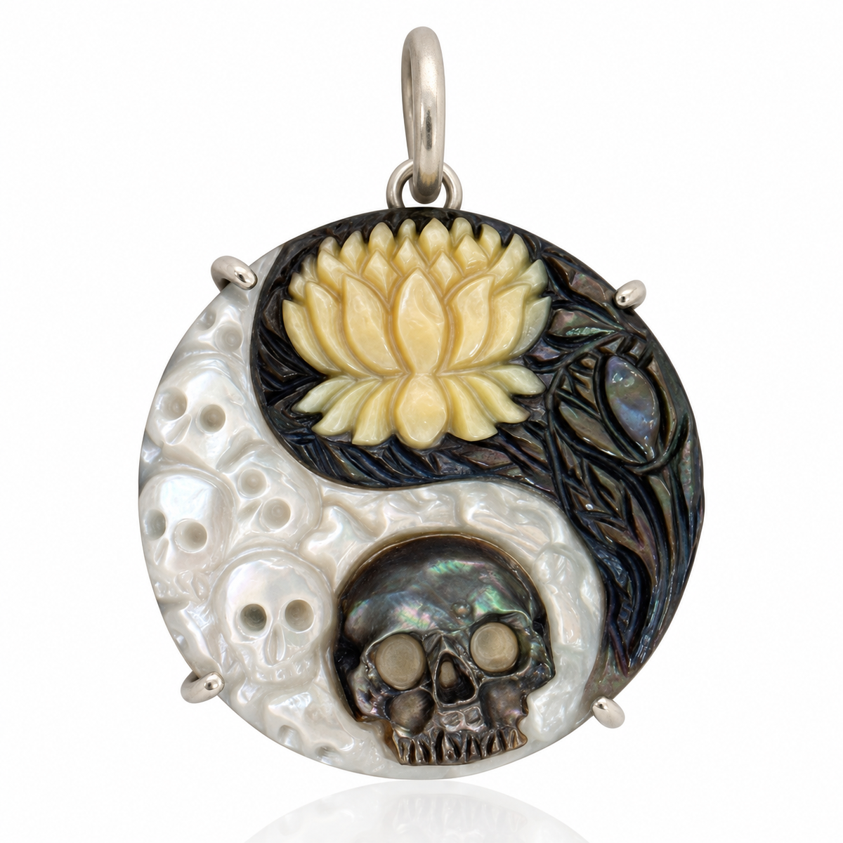 Round hand-carved mother-of-pearl pendant featuring skulls, a golden lotus flower, and dark floral details, finished with a silver bail against a white background.