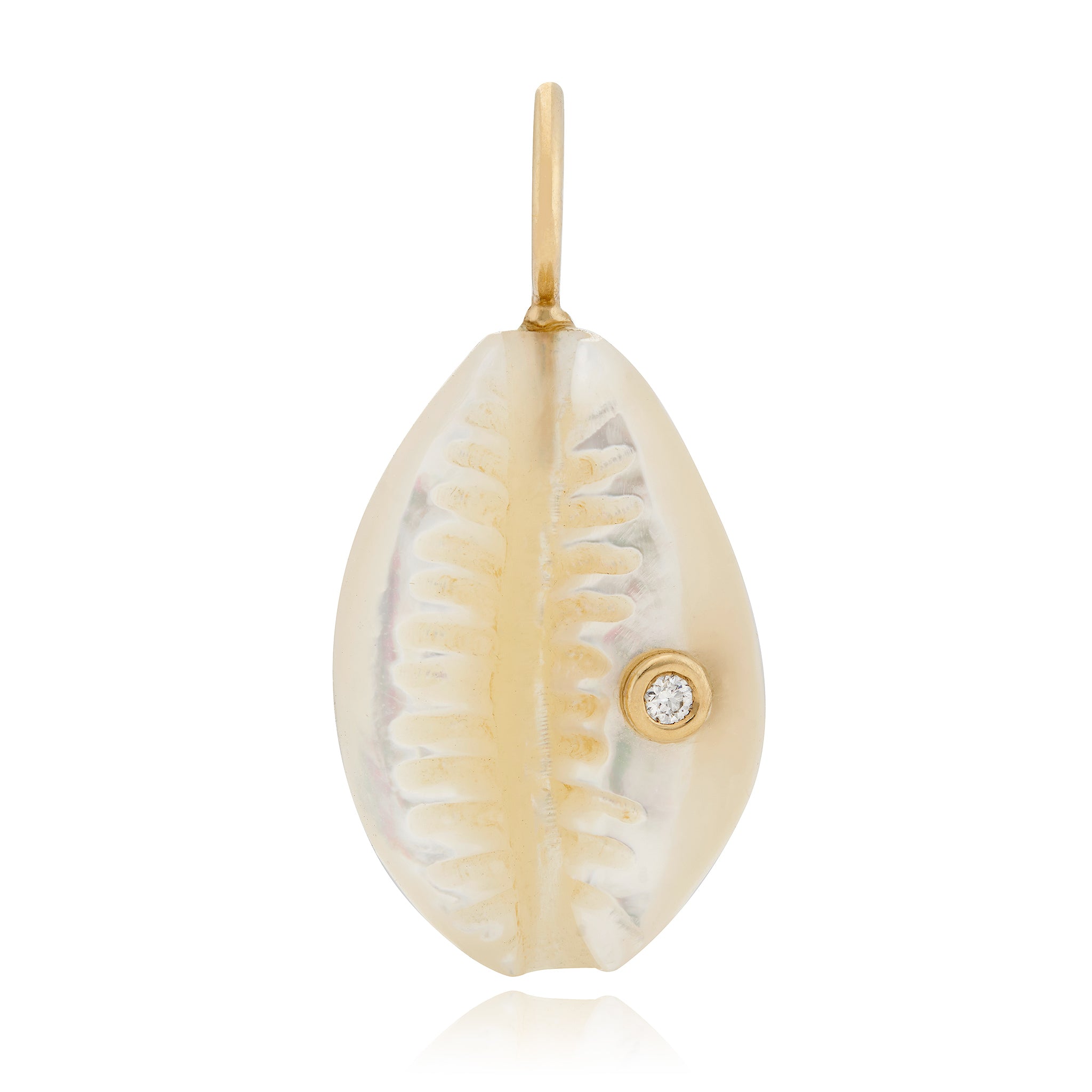 A small cowrie shell charm with a diamond accent, hand-carved from white mother of pearl, set in 14K yellow gold, designed by Maura Green.