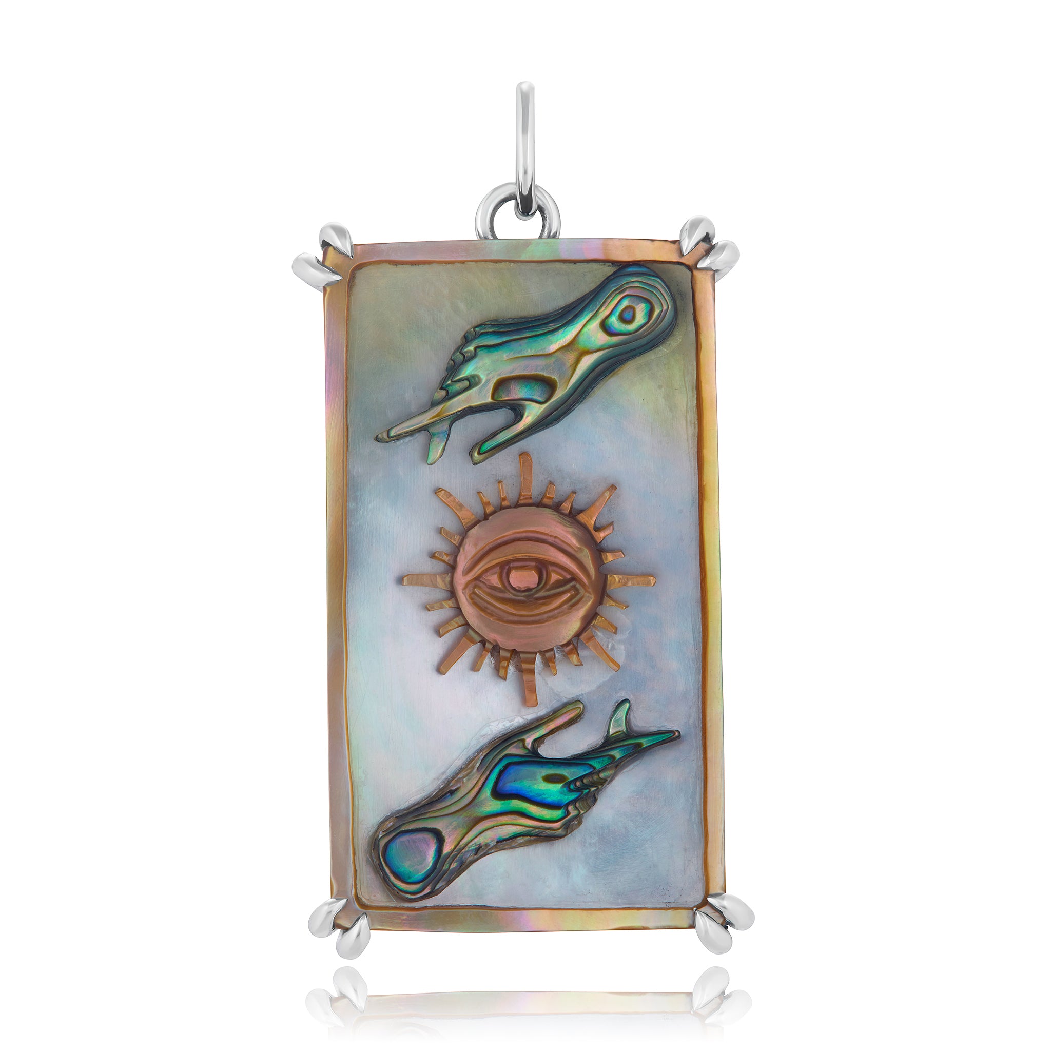 A sterling silver Tarot card pendant with hand carved abalone and mother of pearl, featuring a sun and moon symbol with a human hand in the center. Designed by Maura Green