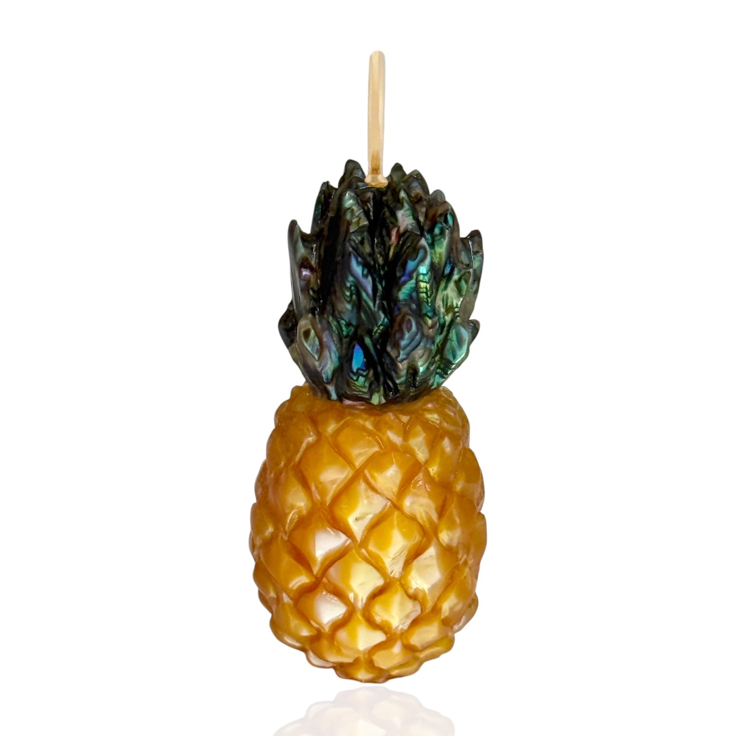 Pineapple charm on a gold bail with a white background designed by maura green