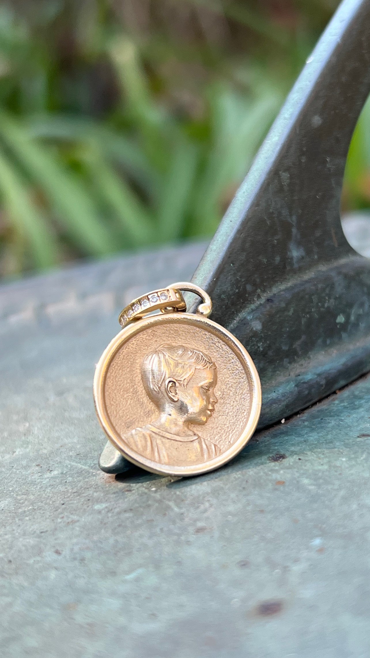 Gold coin with a portrait designed by Maura Green