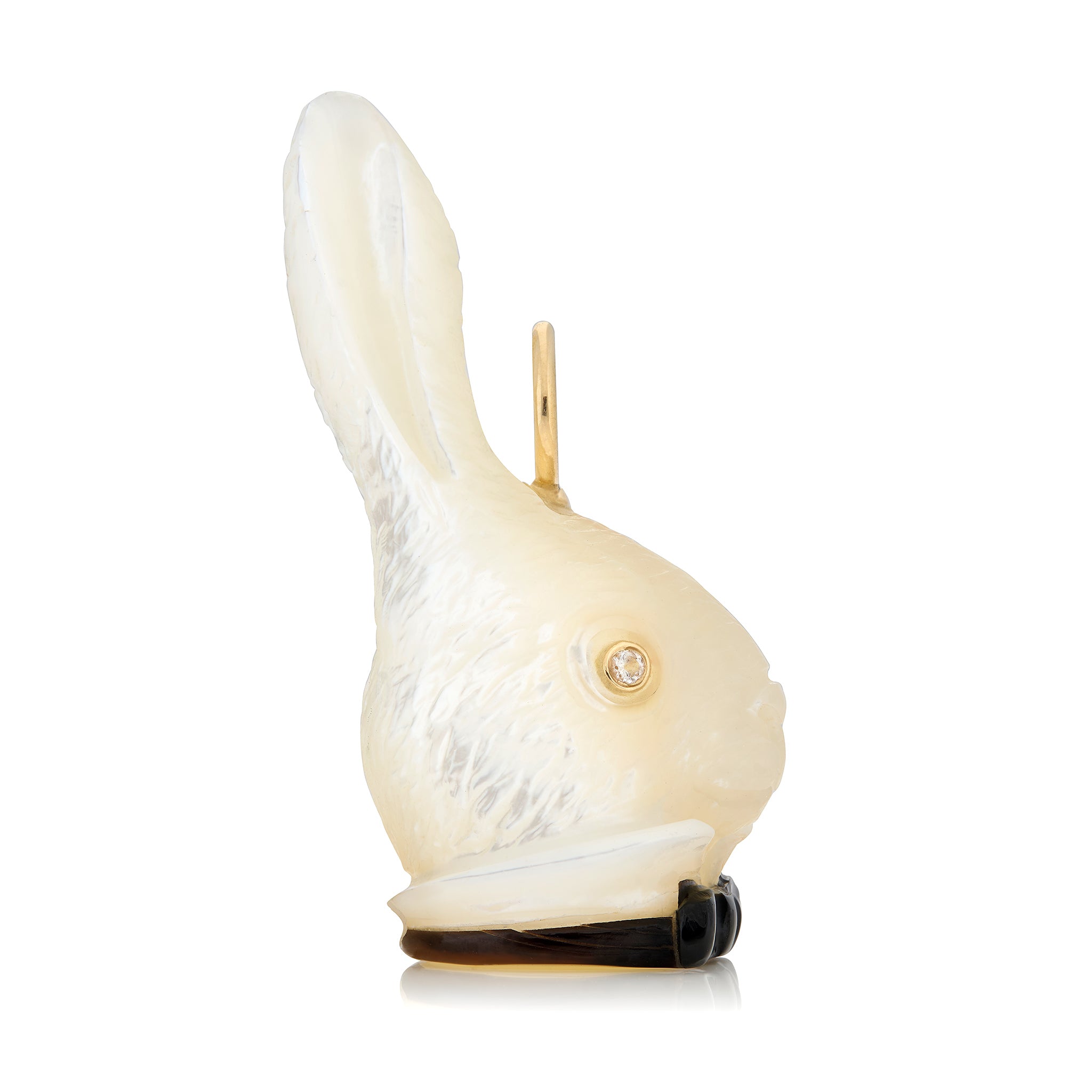 White rabbit head charm with a black bowtie and diamond eyes on a white background. Designed by Maura Green