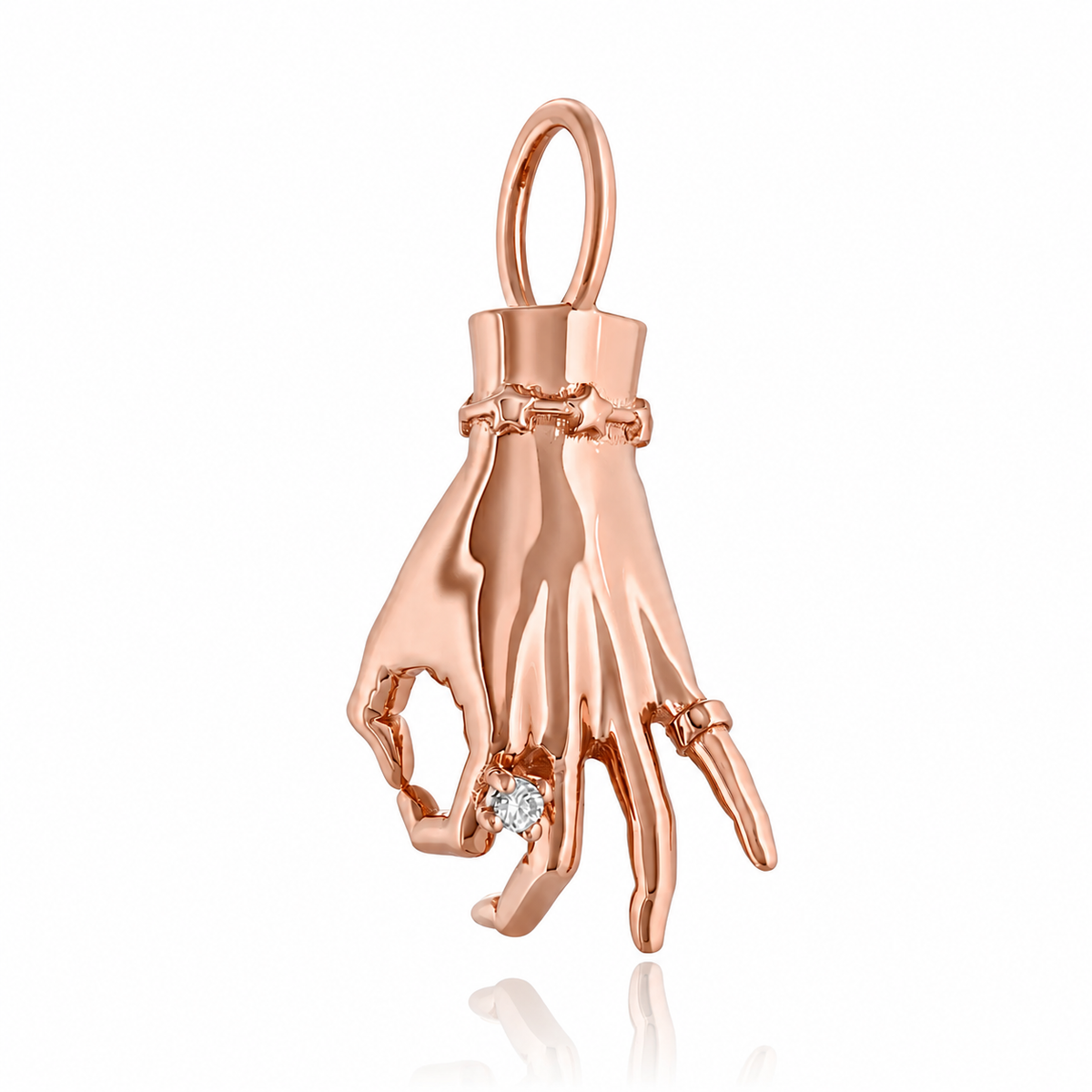 A rose gold ladyfinger charm with a diamond ring on the index finger, attached to a delicate gold chain. Designed by Maura Green