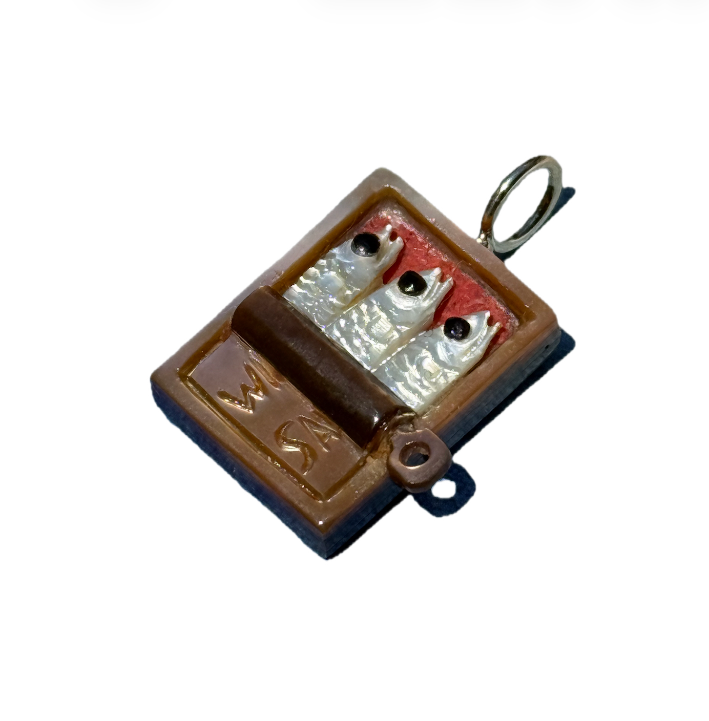 Brown tin with three white sardines on a 14k gold bail on a white background. Designed by maura green