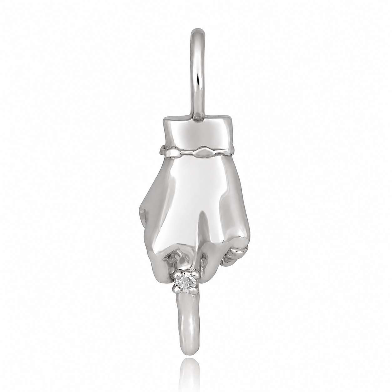 A white gold figural hand charm wearing a diamond ring and making the middle finger gesture designed by Maura Green against a white background